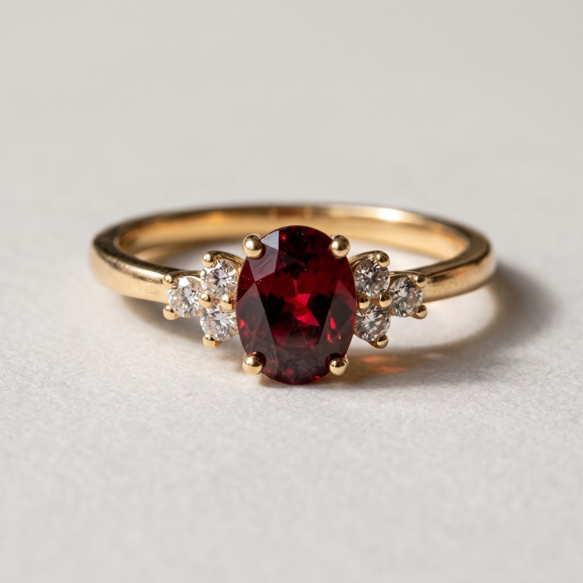 Yellow gold metal variation of the blood red oval lab grown three-stone engagement ring