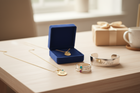 Custom engraved gold band and personalized gemstone jewelry in elegant gift packaging