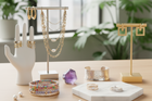 Fashion model wearing 2025 trending fine jewelry featuring layered gold chains and cocktail ring