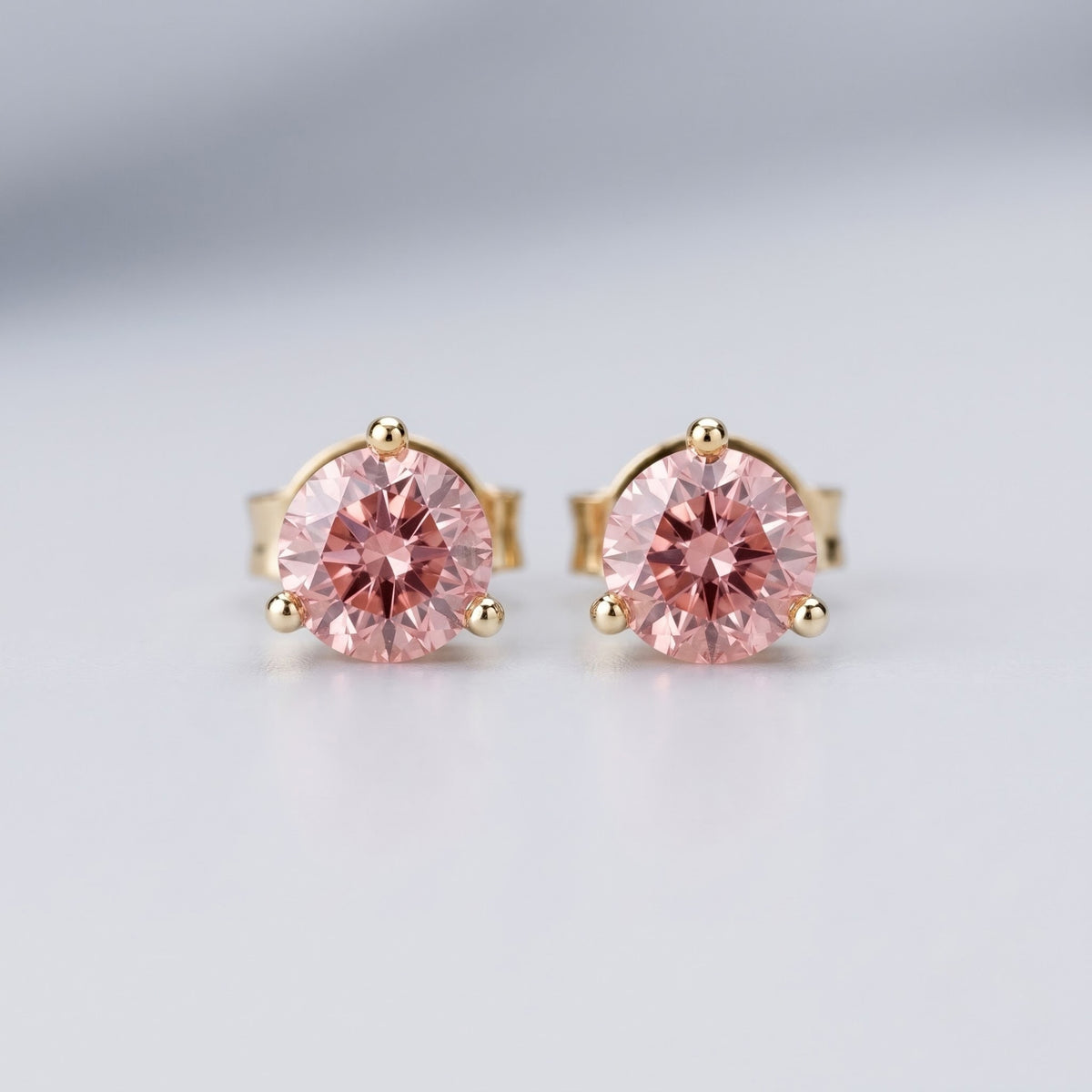 Pink diamond stud earrings in 14K yellow gold