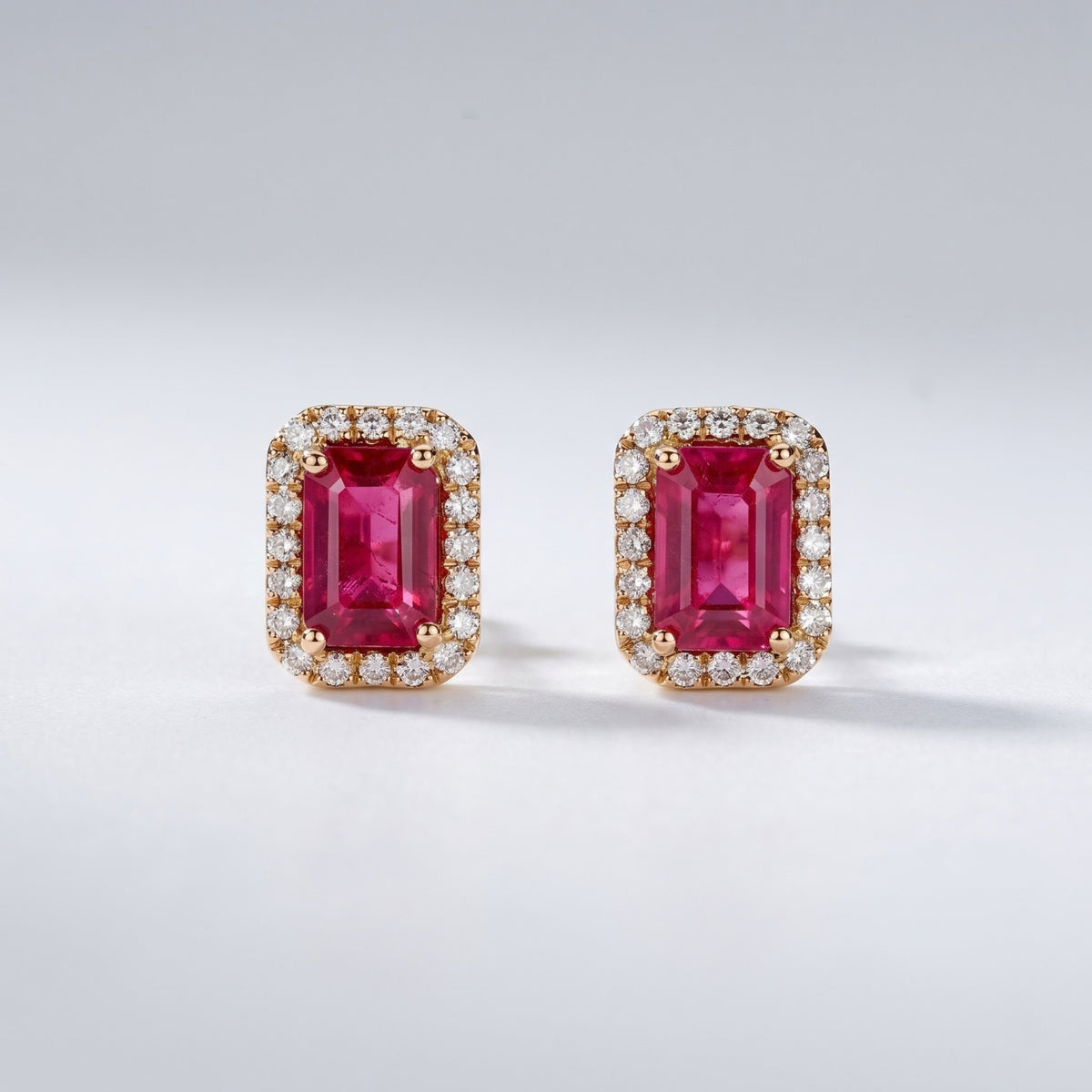 Emerald-cut pink sapphire earrings with round diamond accents