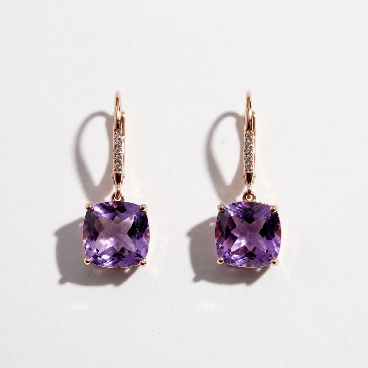 Pair of 14K rose gold cushion cut amethyst and diamond drop earrings with 8.12 TCW purple gemstones