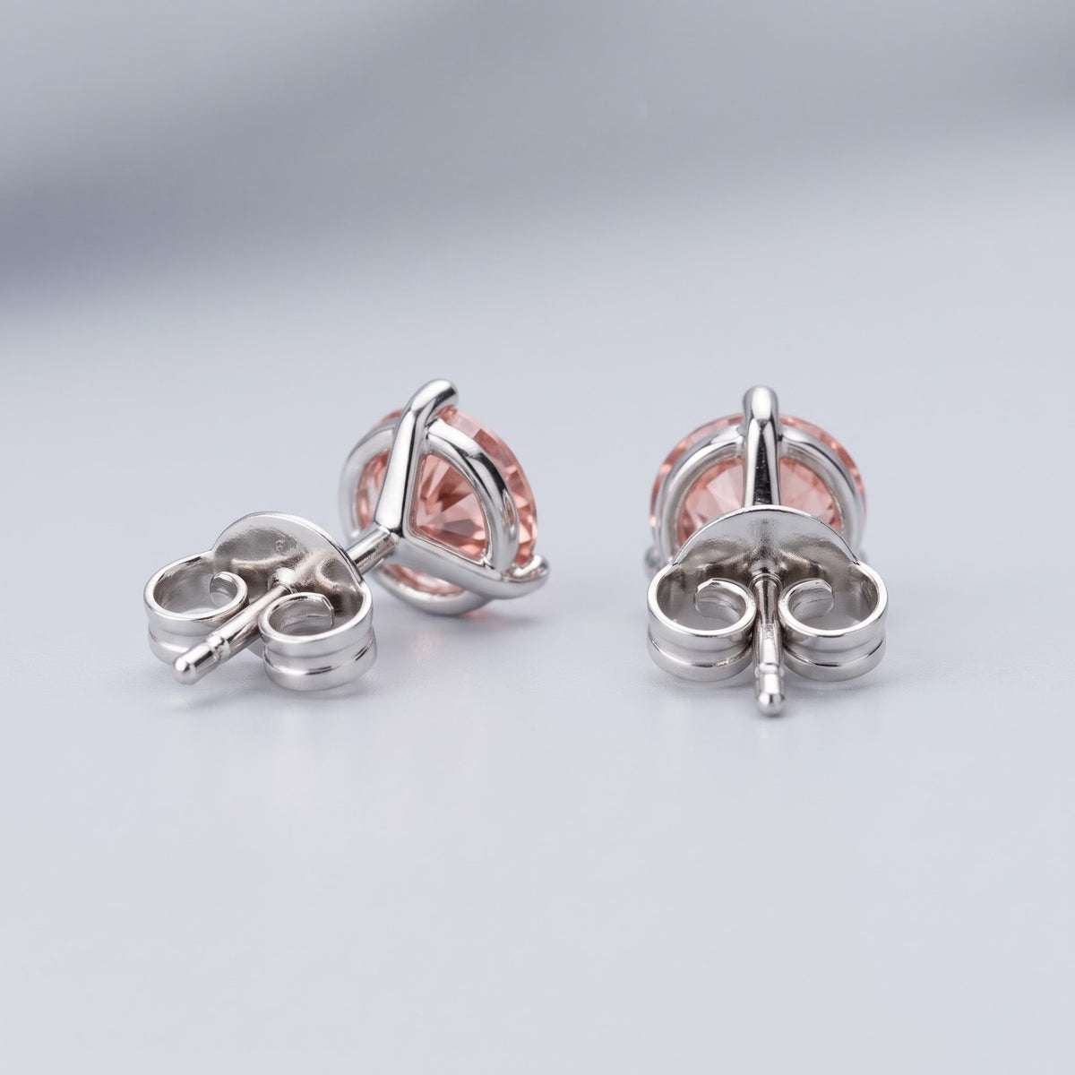 Pink diamond stud earrings in 14K white gold back setting.