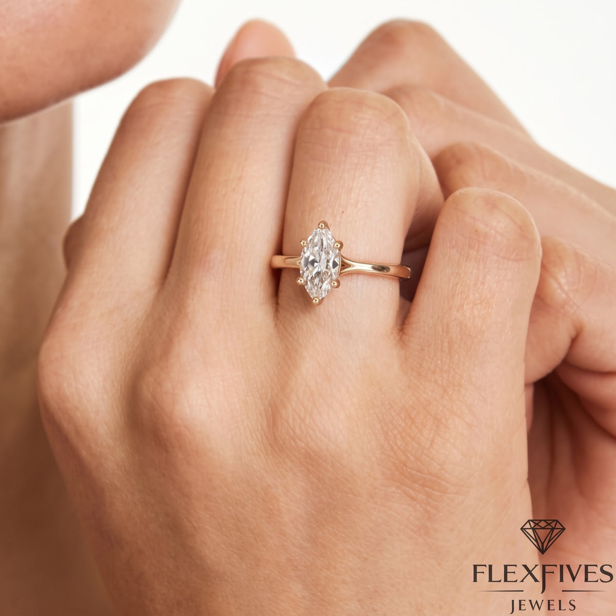 1.50 ctw marquise cut lab-grown diamond six prong solitaire engagement ring in rose gold worn on a model's hand