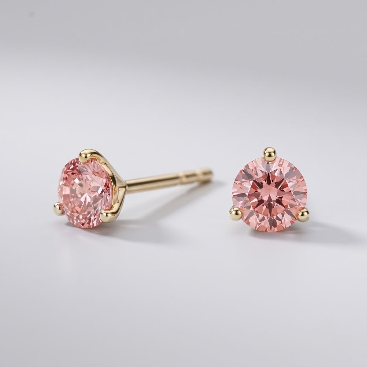 Pink diamond stud earrings in 14K yellow gold