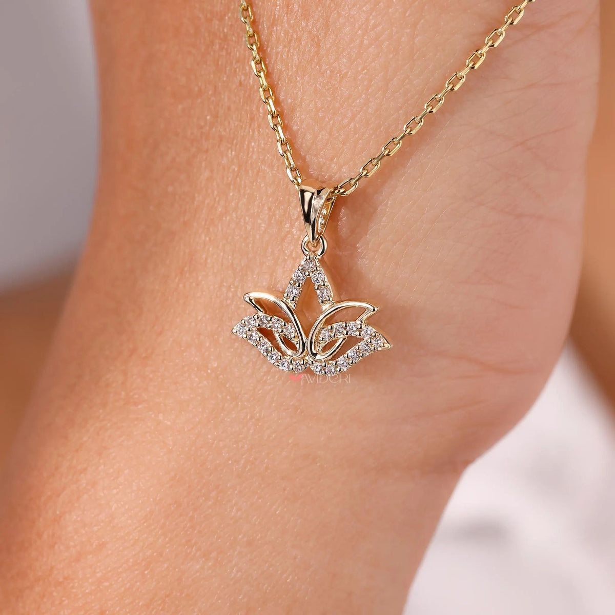 Close-up of the lotus-inspired pendant featuring round-cut lab-grown diamonds.